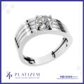 A silver-toned solitaire engagement ring with a round brilliant-cut diamond, presented on a white background with a blue border and the Platizem brand logo at the bottom.