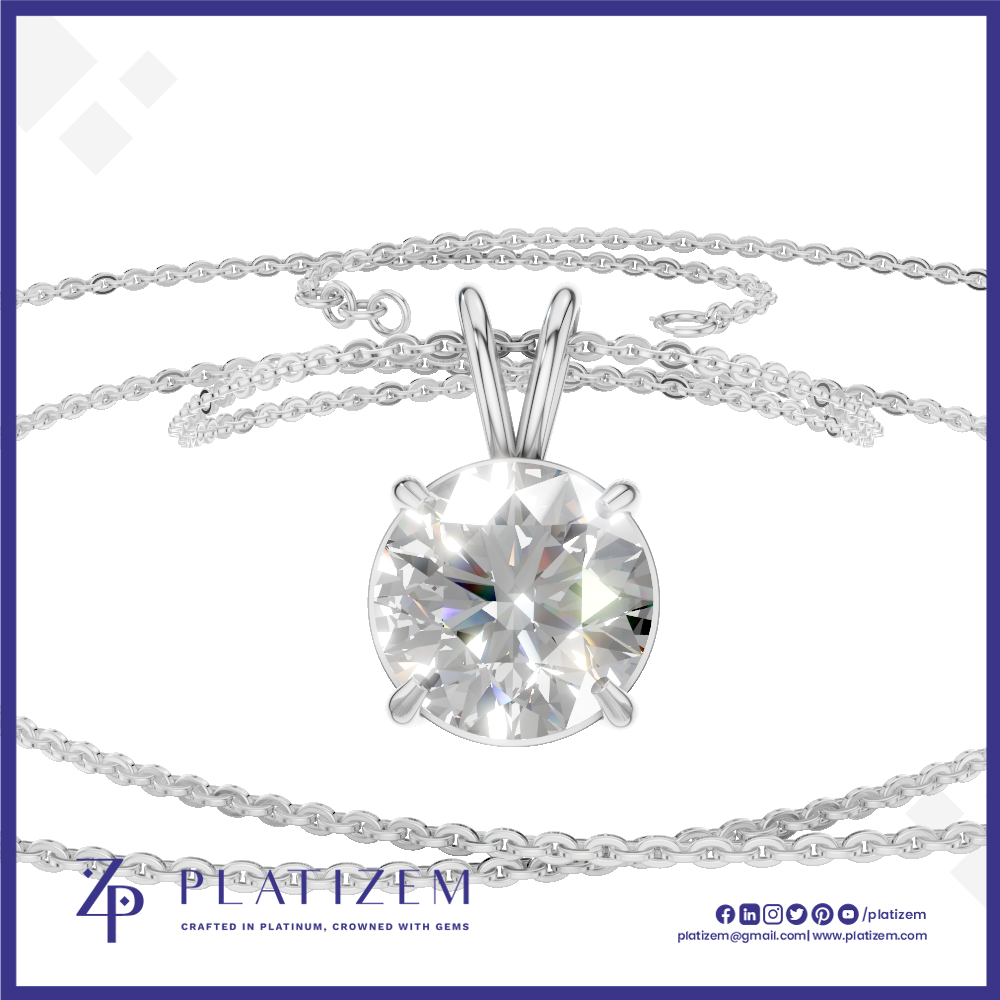 A round brilliant-cut clear gemstone solitaire pendant in a silver-toned setting, suspended on a delicate silver chain against a white background with a blue border and Platizem branding.
