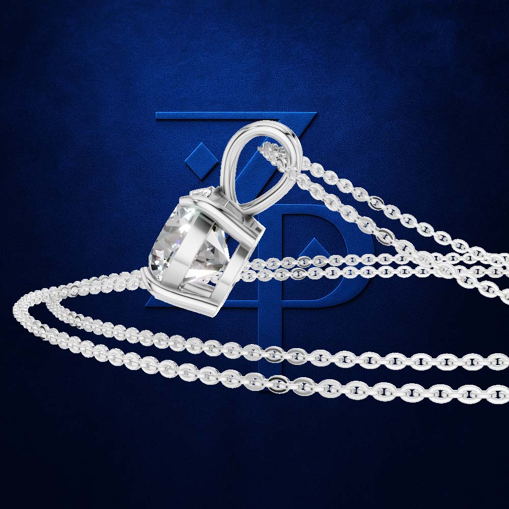 A silver-toned pendant necklace with a clear faceted gemstone in a bezel setting, shown with a matching chain on a dark blue textured background.