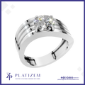 A silver-toned solitaire ring with a round brilliant-cut diamond, featuring a multi-stripe band design, presented on a white background with the Platizem brand logo at the bottom.