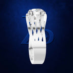 A silver-toned ring with a large clear round gemstone and an openwork band, shown on a dark blue textured background with a faint blue logo behind it.