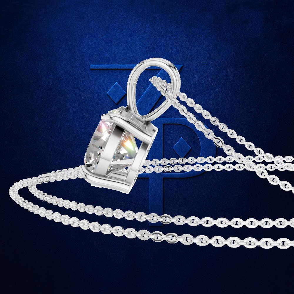 A silver-toned pendant necklace with a faceted gemstone in a rectangular setting, shown on a dark blue textured background with a large stylized letter behind it.