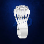 A white gold or platinum solitaire ring with a large round brilliant-cut diamond, set against a dark textured blue background with a subtle blue geometric logo behind it.