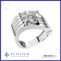 A silver-toned solitaire engagement ring with a round brilliant-cut diamond, presented on a white background with a blue border and the Platizem brand logo at the bottom.