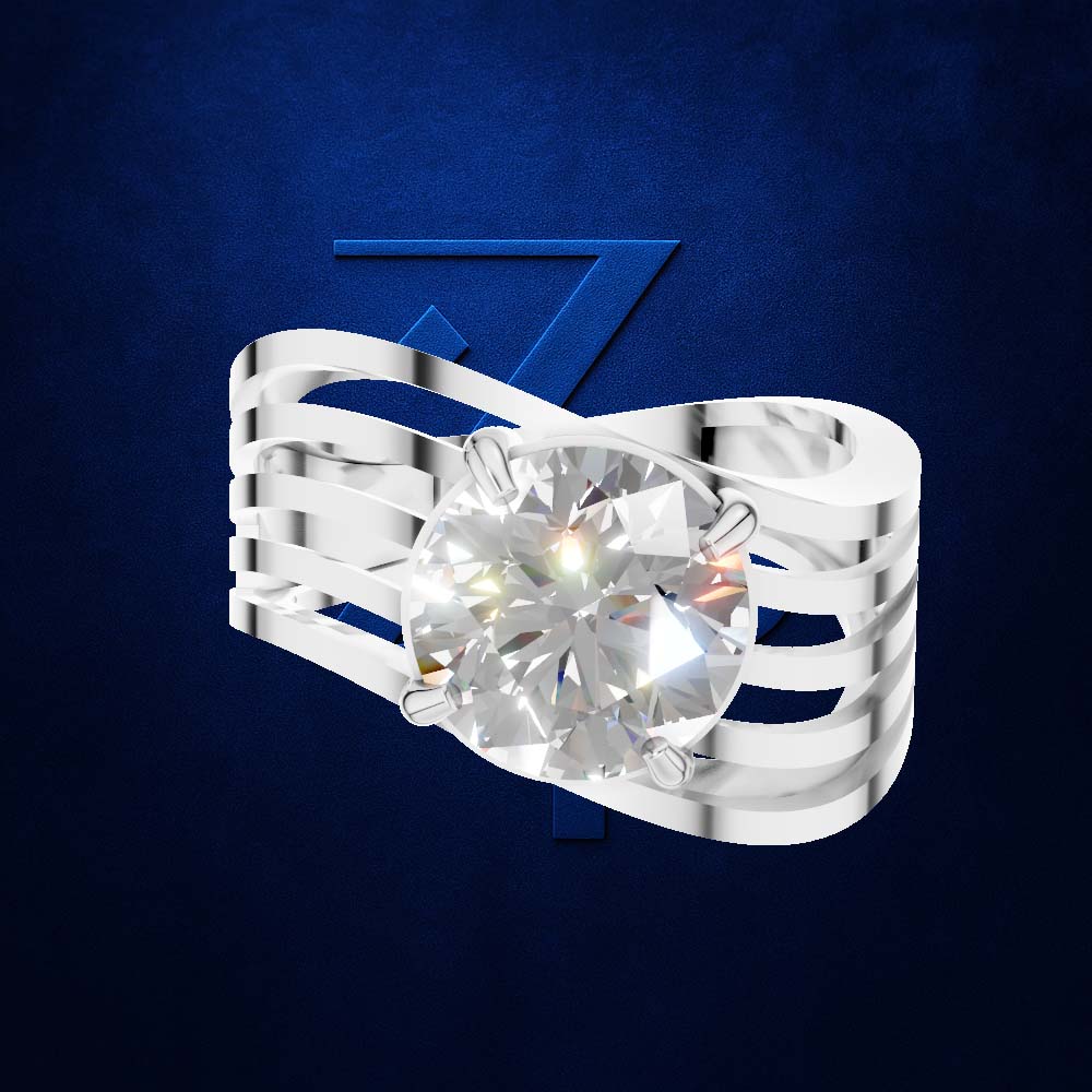 A silver-toned ring with a large round clear gemstone, shown on a dark blue textured background with a faint blue stylized 'Z' behind it. Per the color rules, the clear gemstone does not contribute a color, so only the silver metal setting is counted.