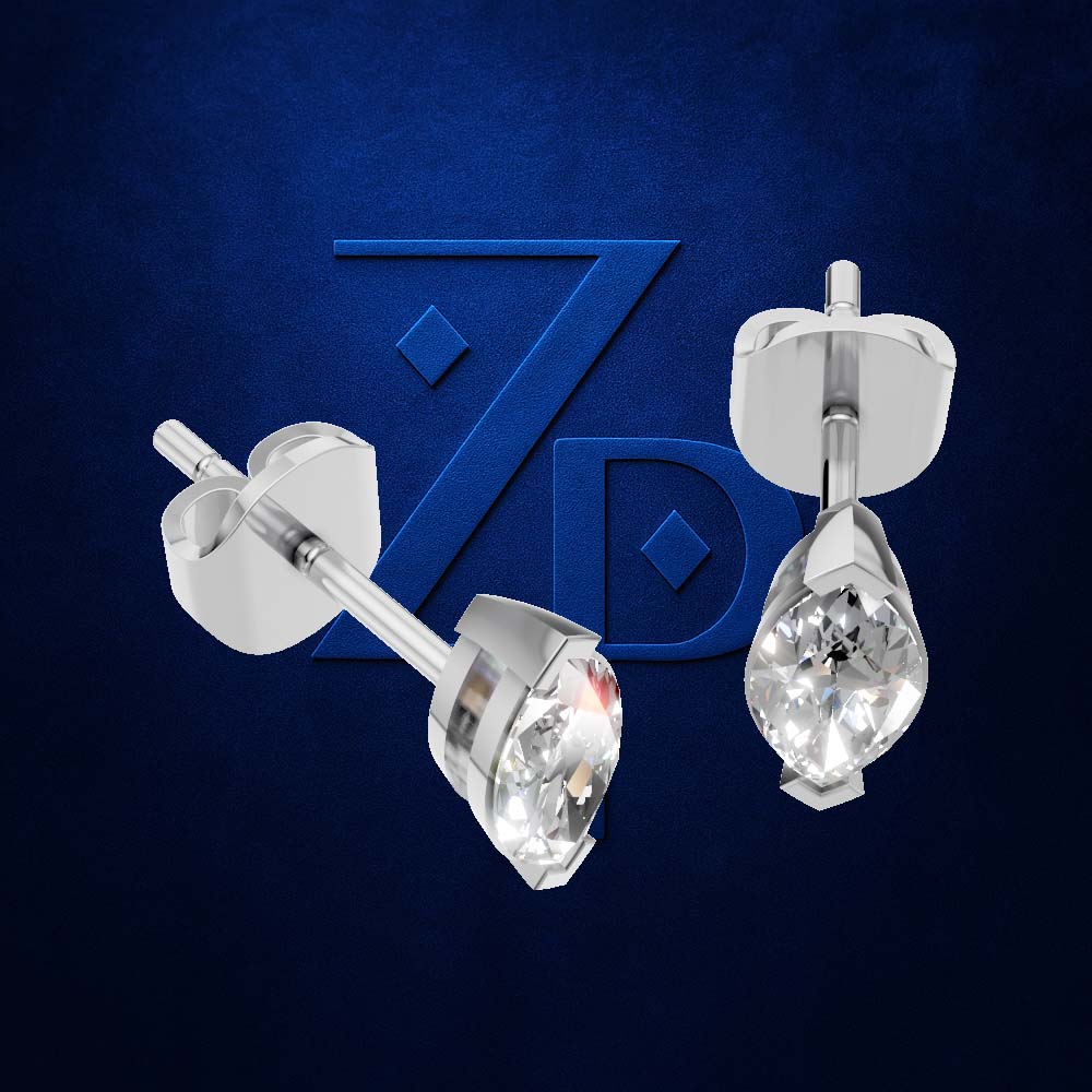 A pair of silver stud earrings with clear teardrop-cut gemstones, shown from front and side angles against a textured dark blue background with a stylized 'ZD' logo.