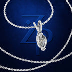 A silver-tone necklace with a marquise-cut clear gemstone pendant, displayed against a dark blue textured background with a large stylized 'ZP' logo.