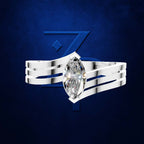 A silver-toned ring with a marquise-cut clear gemstone, shown against a dark blue textured background with a large stylized blue Z logo behind it. Per the rules, the clear gemstone does not contribute a color, so only the surrounding metal setting is considered for product color identity.