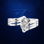 A silver-toned ring with a marquise-cut clear gemstone, shown against a dark blue textured background with a stylized blue Z logo.