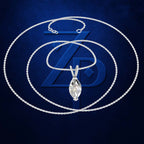 A silver chain necklace with a marquise-cut clear gemstone pendant, displayed against a dark blue textured background with a large stylized blue ZD logo behind it.