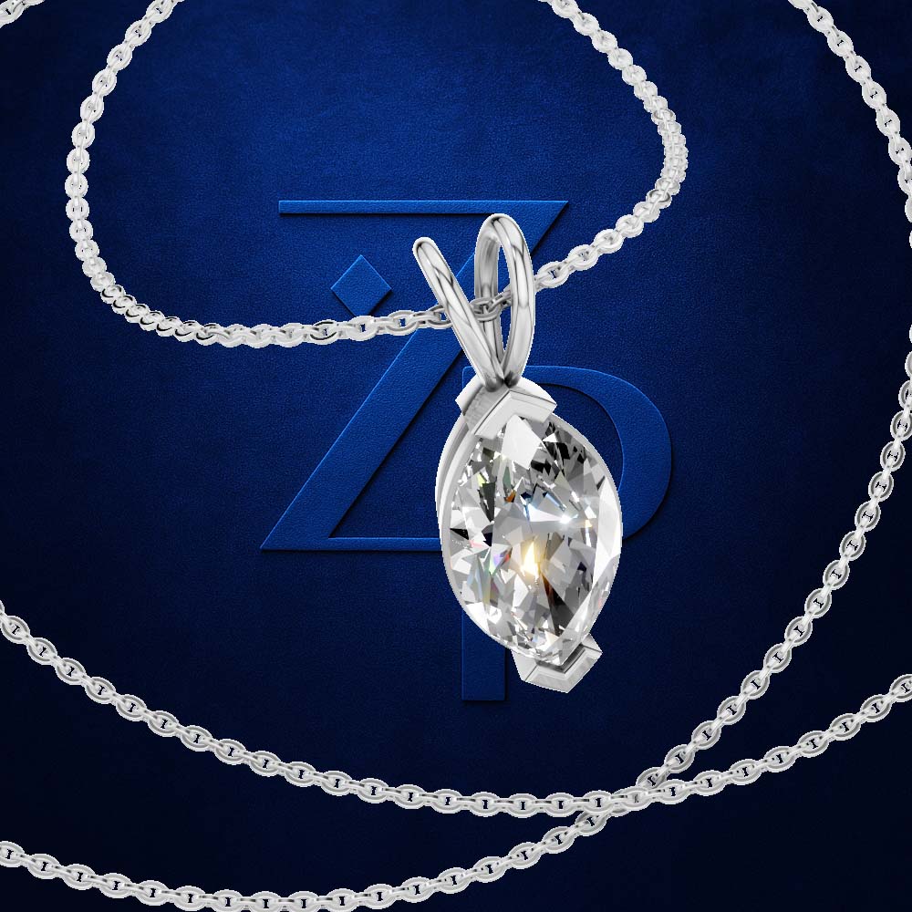 A silver-tone chain necklace with a teardrop-shaped clear gemstone pendant, displayed against a dark blue background with a large blue 'ZP' logo.