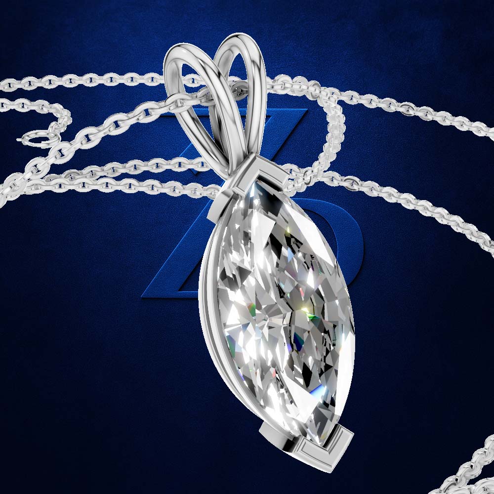 A silver-tone pendant necklace featuring a large marquise-cut clear gemstone, shown against a dark blue background with a chain draped behind it.