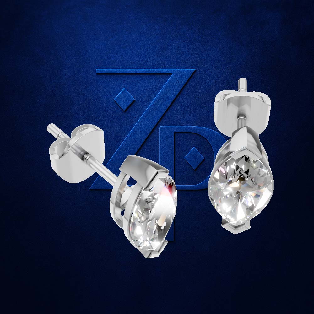 A pair of silver-toned teardrop stud earrings with clear faceted gemstones, shown from front and side angles against a dark blue textured background with a subtle stylized 'ZP' logo.