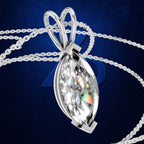 A silver-toned marquise-shaped pendant necklace with a large clear faceted gemstone, shown on a dark blue background with chain loops behind it.