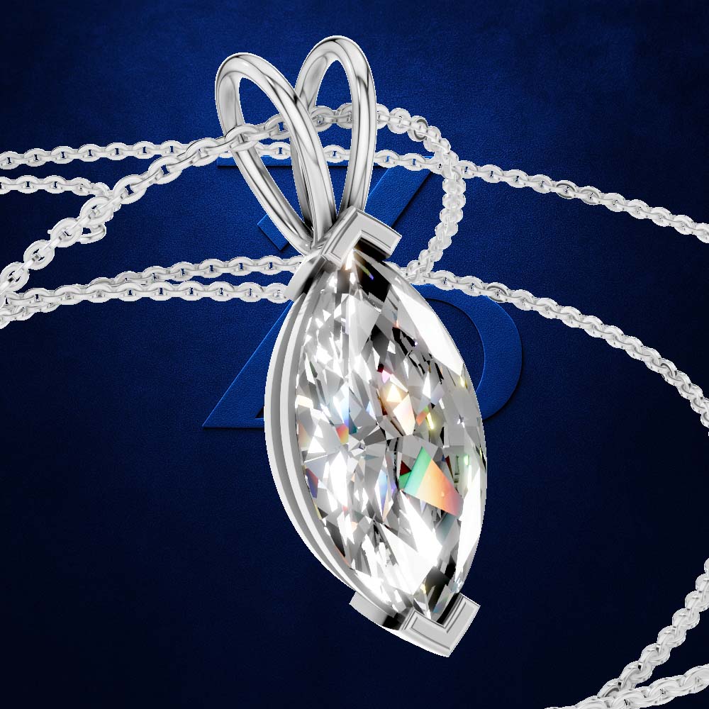 A silver-toned marquise-shaped pendant necklace with a large clear faceted gemstone, shown on a dark blue background with chain loops behind it.
