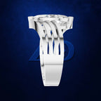 A white geometric ring with a large clear gemstone, shown against a dark blue textured background with a faint blue logo behind it.