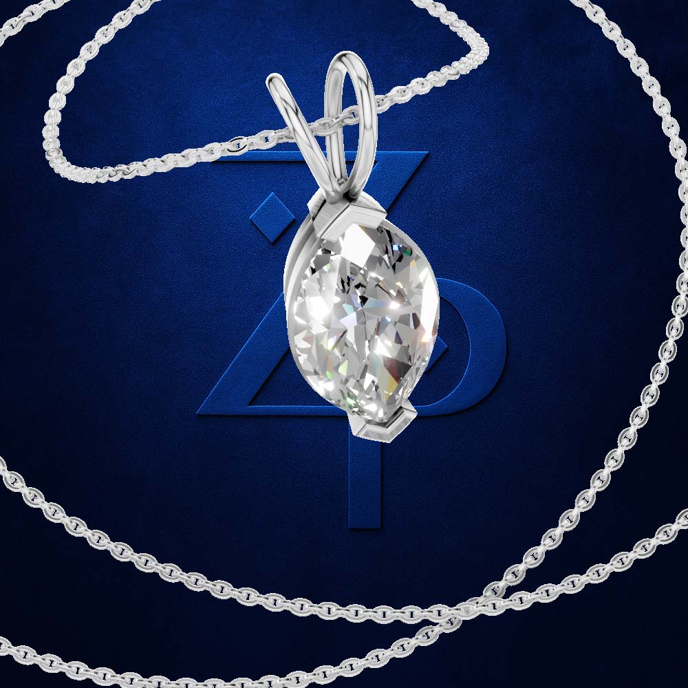 A silver-toned pendant necklace with a marquise-cut clear gemstone in a bezel setting, shown on a dark blue background with a large stylized 'Z' and a coiled chain.