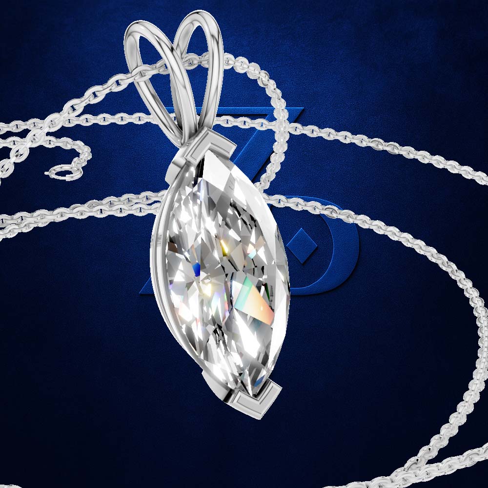 A silver-toned teardrop marquise pendant necklace with a faceted clear gemstone, shown on a dark blue textured background with a chain draped behind it.