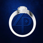 A silver-toned ring with a large oval face featuring a blue embossed monogram logo, photographed on a textured dark blue background.