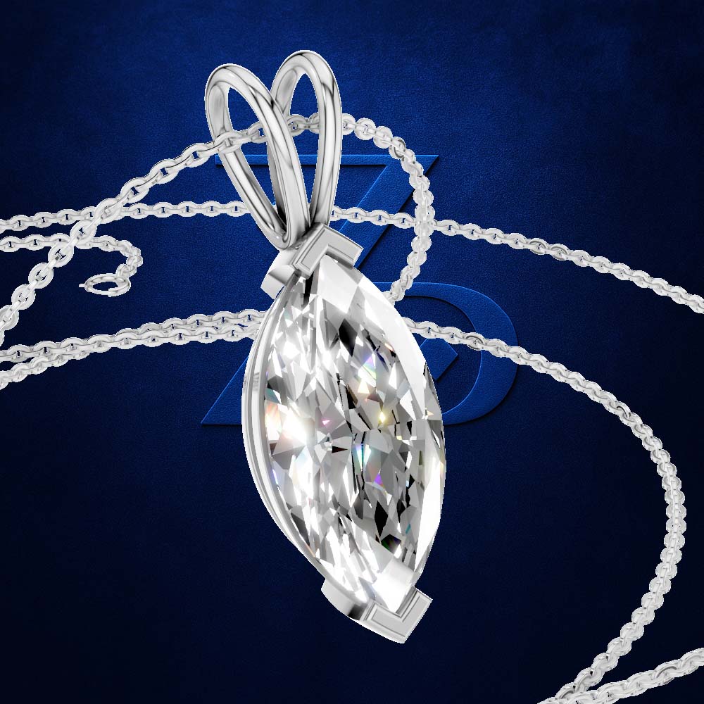 A silver-toned marquise-shaped pendant necklace with a large clear faceted gemstone, shown on a dark blue textured background with part of the chain visible.