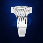 A white gold or platinum ring featuring a large clear round gemstone in a wide, multi-prong setting with an intricate, openwork filigree band, shown against a dark blue textured background.