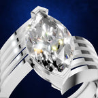 A silver-toned ring featuring a large marquise-cut clear gemstone in a prong setting, shown against a dark blue textured background.