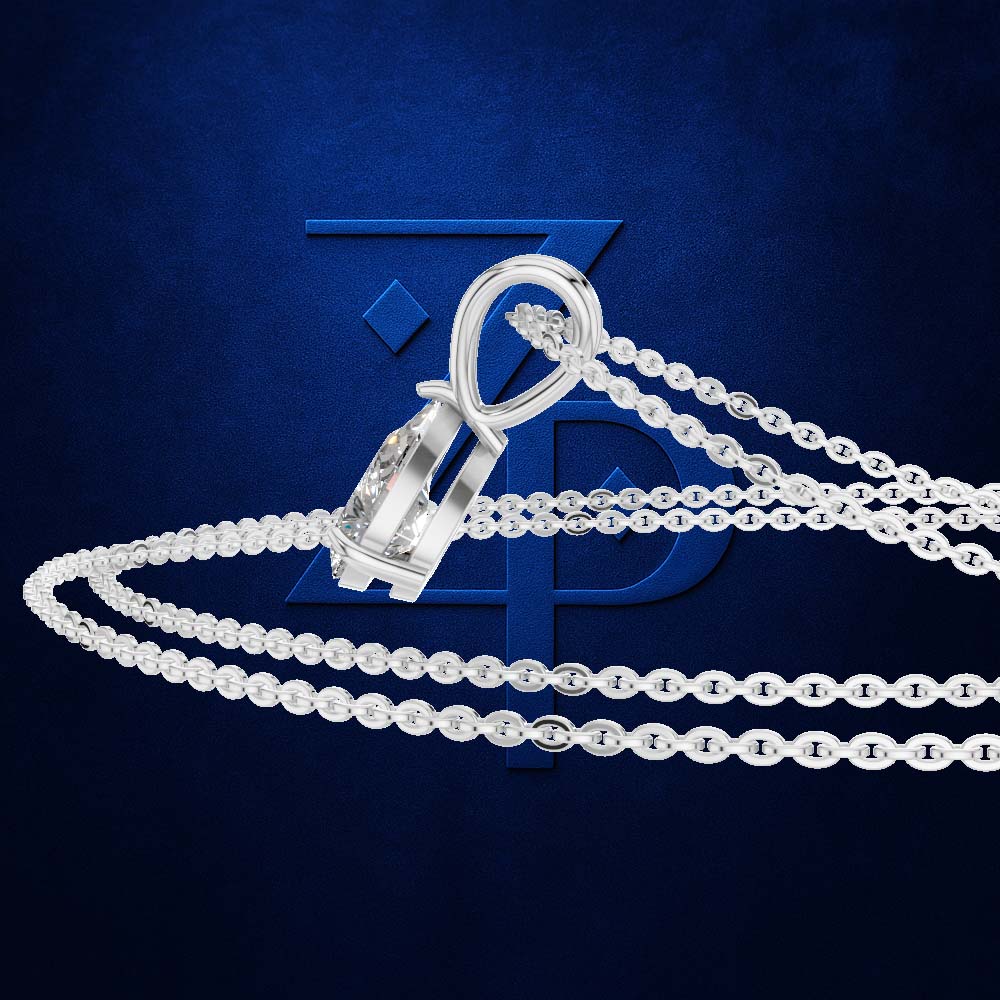A silver-toned chain necklace with a geometric pendant featuring a clear faceted gemstone, displayed against a textured dark blue background with a subtle logo.