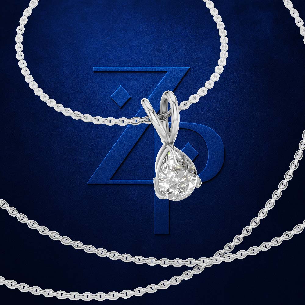 A silver-toned necklace with a teardrop-shaped clear gemstone pendant, arranged on a dark blue textured background with a large embossed ZP logo behind it.