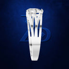 A silver-toned ring with a large clear gemstone, shown against a dark blue textured background with a subtle stylized logo behind it.