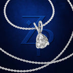 A silver-toned necklace with a teardrop-shaped clear gemstone pendant, shown against a dark blue textured background with a large stylized 'ZP' logo behind it.