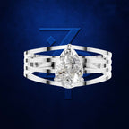 A silver-toned multi-band ring featuring a large pear-cut clear gemstone, presented against a textured dark blue background with a stylized blue 'Z' logo.