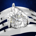 A pear-cut diamond ring with a silver-toned setting, shown in a close-up studio-style render against a dark blue background with white curved ribbon-like accents.