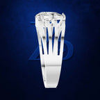 A white gold or platinum ring featuring a large, bezel-set clear gemstone, displayed against a dark textured blue background with a subtle blue geometric logo behind it.