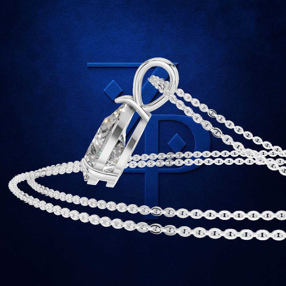 A silver-toned pendant necklace with a large clear faceted gemstone in a prong setting, shown on a dark blue textured background with a large stylized blue letter behind it.
