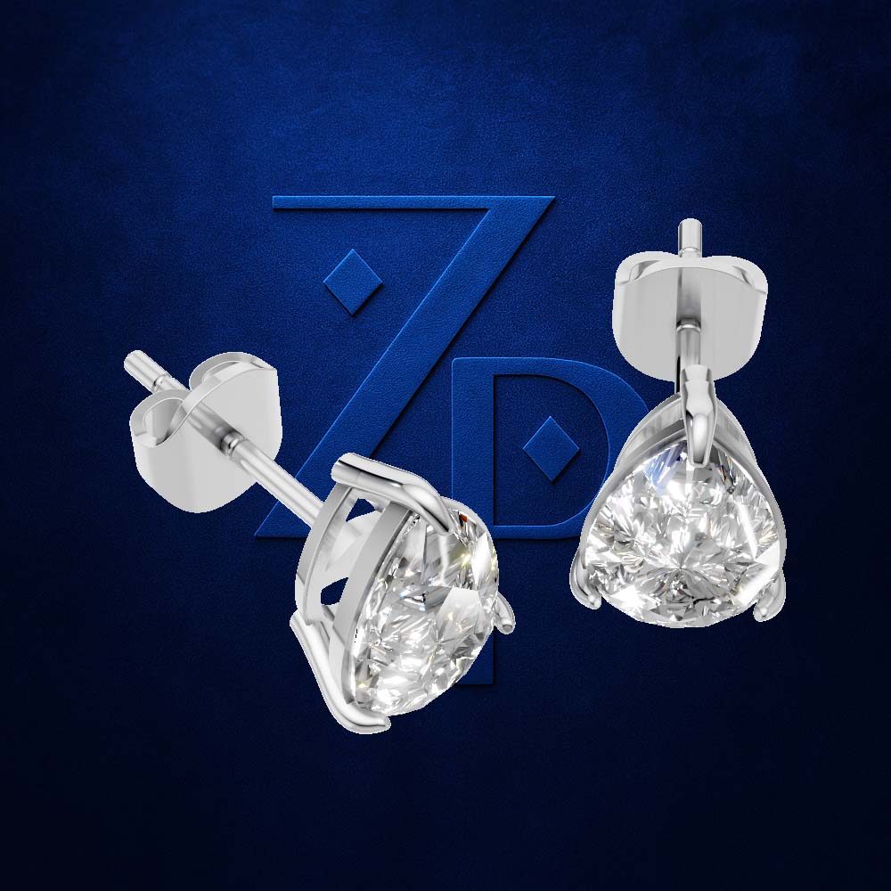 A pair of silver stud earrings with pear-cut clear gemstones, displayed against a dark blue textured background with a stylized blue 'ZD' logo.