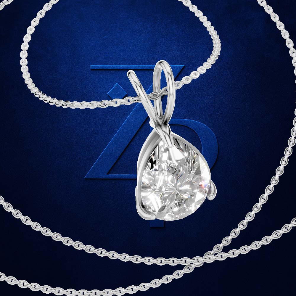A silver-toned necklace with a teardrop-shaped clear gemstone pendant, shown on a dark blue background with a large stylized 'Z' logo behind it.