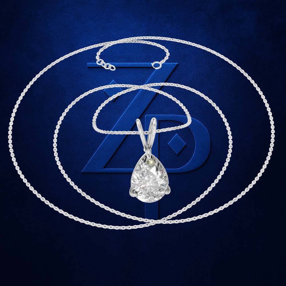 A silver-tone necklace with a teardrop-shaped clear gemstone pendant, displayed against a dark blue textured background with a large stylized 'ZD' logo behind it.