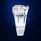 A silver-toned ring with a large clear gemstone in a prong setting, shown against a dark blue textured background with a faint blue logo behind it.