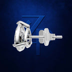 A polished silver-tone stud earring with a clear round gemstone and butterfly back, shown in side profile against a dark blue textured background with a subtle stylized 'Z' logo.