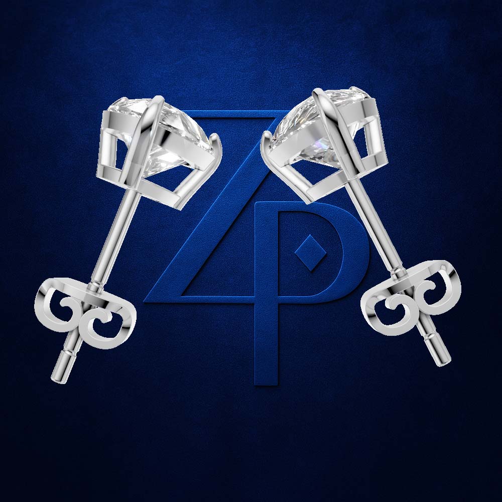 A pair of silver-toned stud earrings with clear gemstones and decorative key-shaped backings, displayed on a dark blue textured background with a large blue monogram behind them.