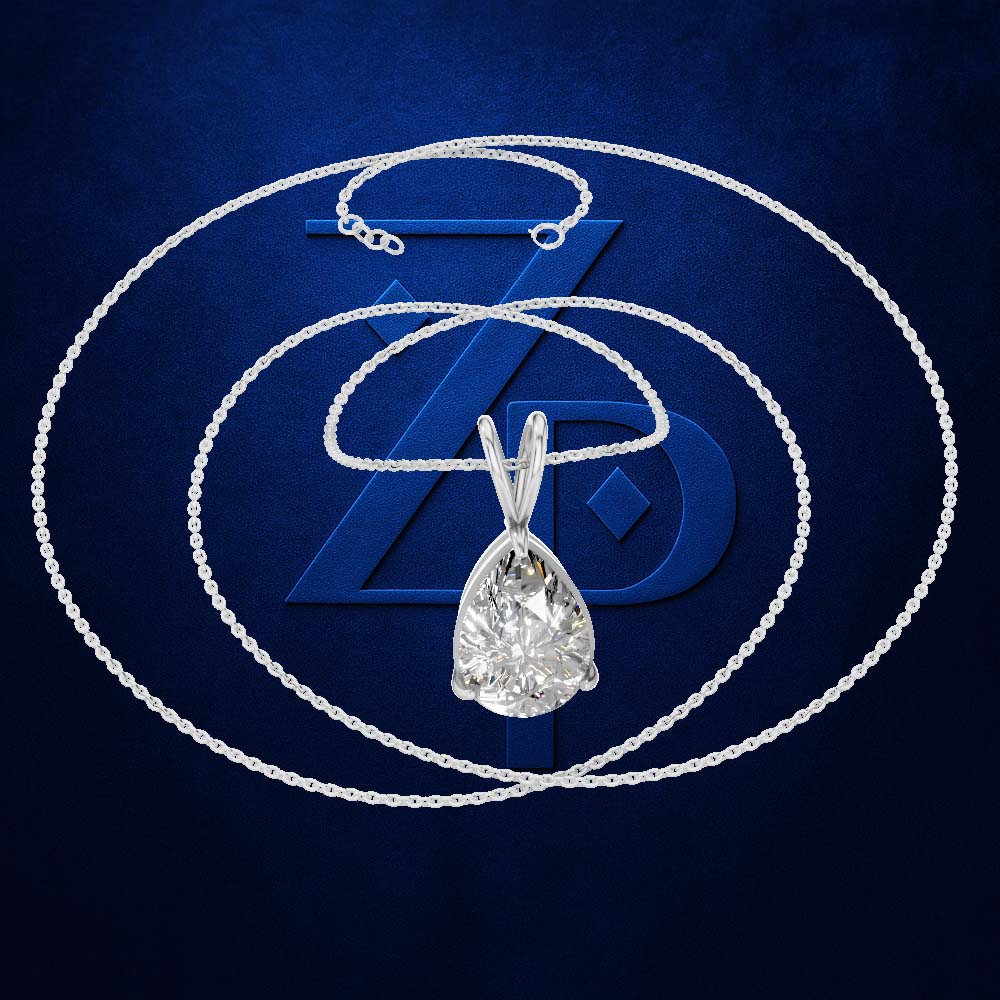 A pear-cut diamond pendant necklace in a silver-toned setting on a matching chain, arranged in concentric circles over a dark blue textured background with a large stylized 'ZD' logo behind it.