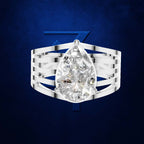 A silver-toned ring featuring a large pear-cut clear gemstone, shown against a dark blue textured background with a stylized blue Z logo behind it. Per the schema, clear gemstones do not contribute to the color mapping, so only the surrounding metal color is considered.