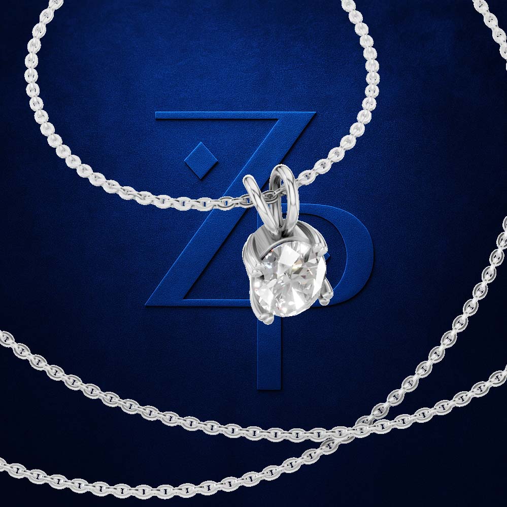 A silver-tone solitaire necklace with a clear round-cut gemstone pendant, shown on a dark blue textured background with a large stylized 'ZP' logo behind it.