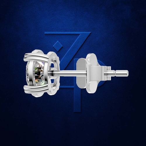 A single silver stud earring shown in side profile against a textured dark blue background with a large stylized 'Z' logo behind it. The earring features a bezel-set clear gemstone in a silver setting with a post and butterfly back.
