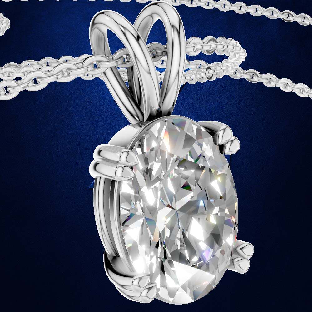 A close-up studio shot of a silver-toned oval pendant necklace with a large clear faceted gemstone, shown against a dark blue background with part of the chain visible at the top.