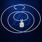 A silver-toned necklace with a clear gemstone pendant, displayed against a dark blue textured background with a large stylized 'ZD' logo behind it.