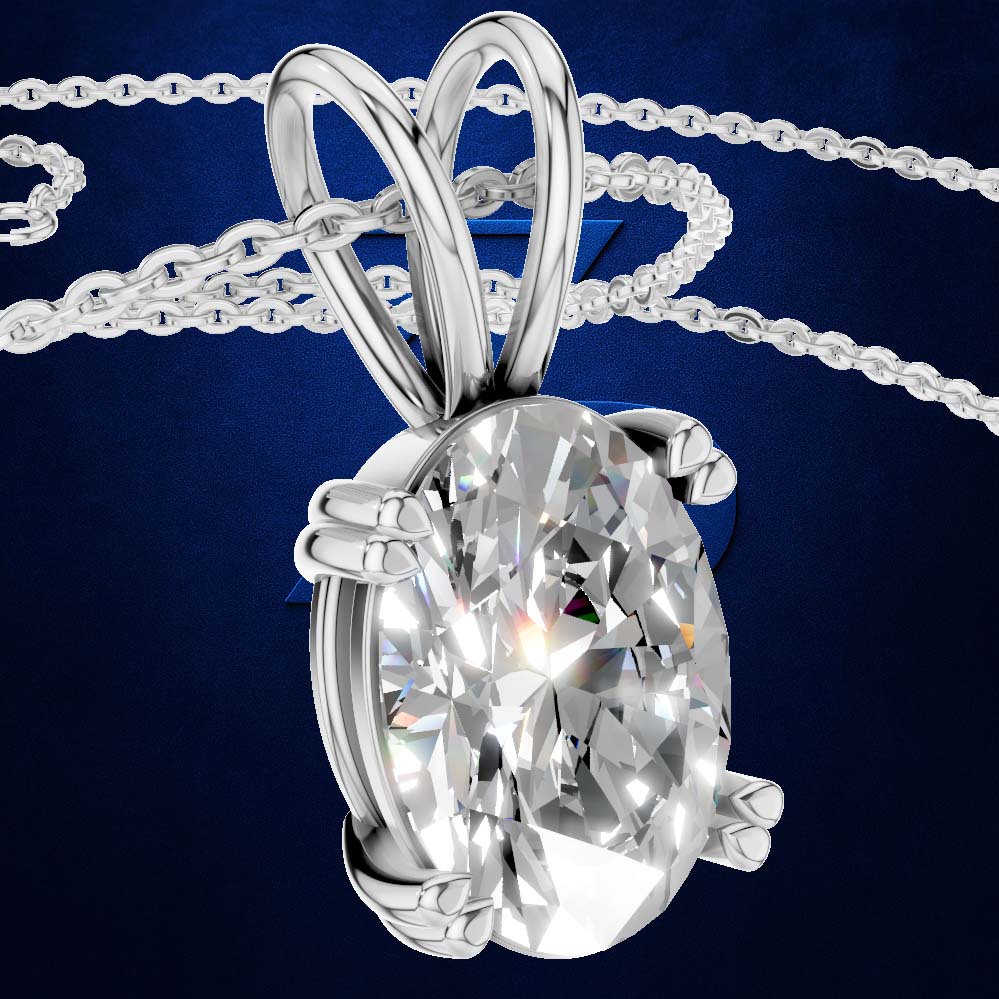 A silver-toned oval pendant necklace featuring a large, brilliant-cut clear gemstone in a prong setting, suspended from a matching chain against a dark blue background.