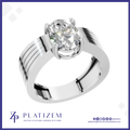 A polished silver-toned solitaire engagement ring with a large oval-cut clear gemstone in a prong setting, shown on a white background with the brand name PLATIZEM at the bottom.