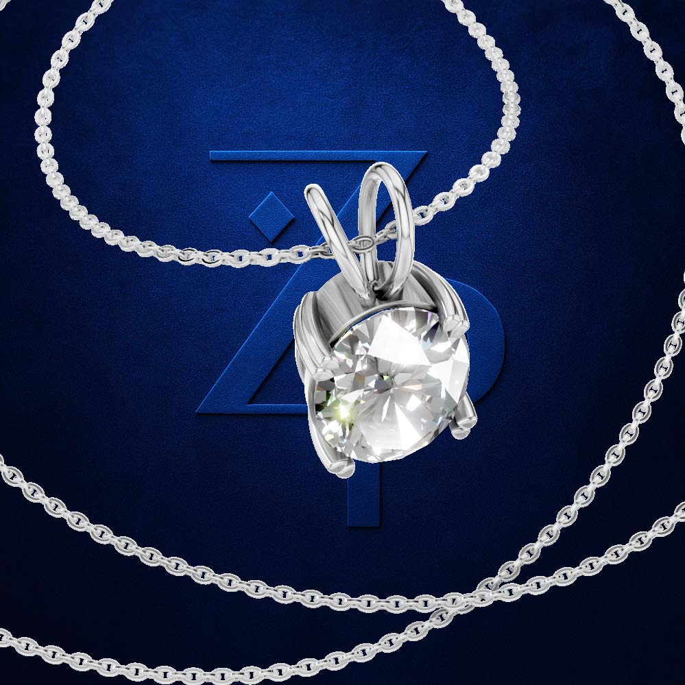 A silver-toned necklace with a round bezel-set clear gemstone pendant, shown on a dark blue textured background with a large stylized 'Z' logo behind it.