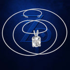 A silver-toned chain necklace with a large clear oval pendant, arranged in concentric circles on a dark blue background with a stylized blue ZP logo.